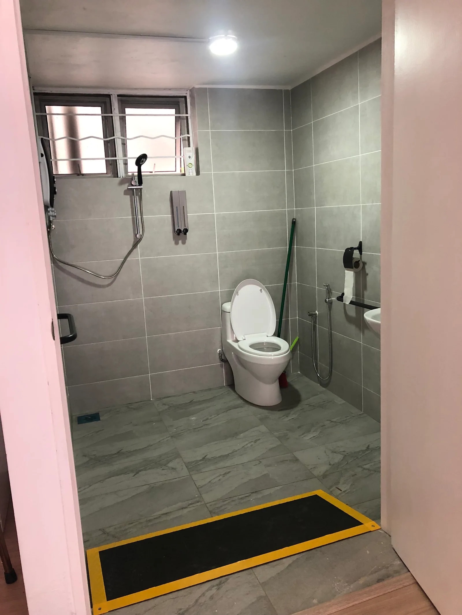 Bathroom with a level shower and grab rails at Adam & Eve Elderly Home
