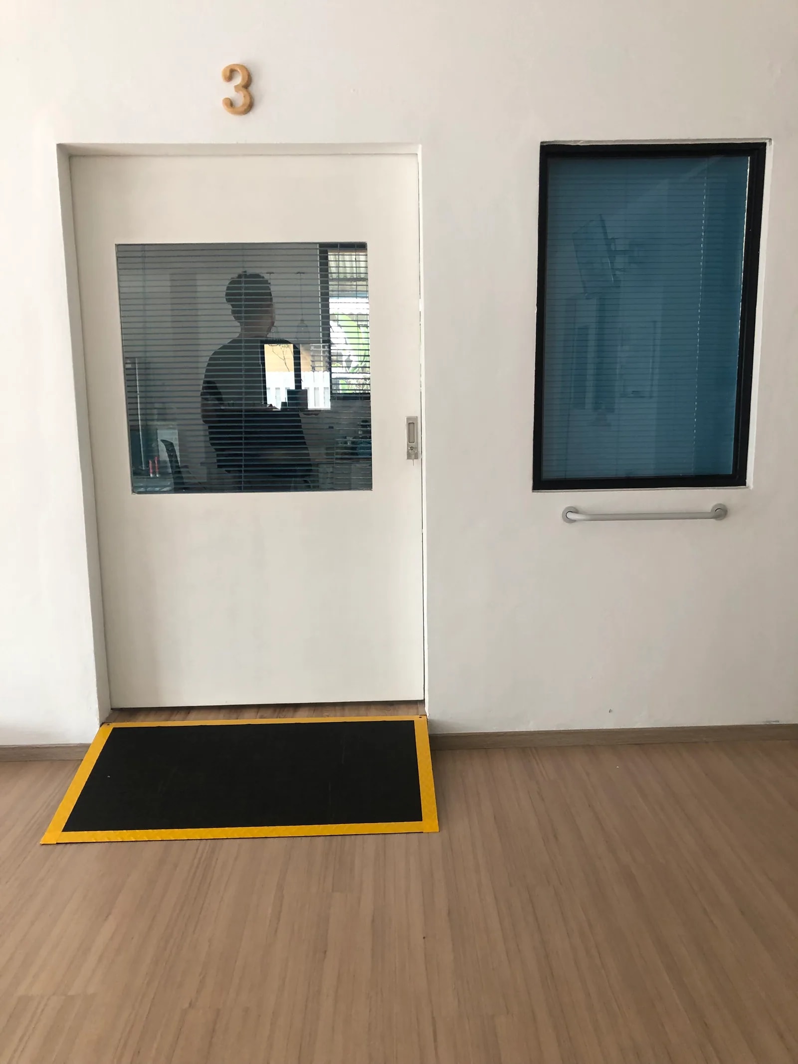 Resident room entrance with a window and handrail at Adam & Eve Elderly Home