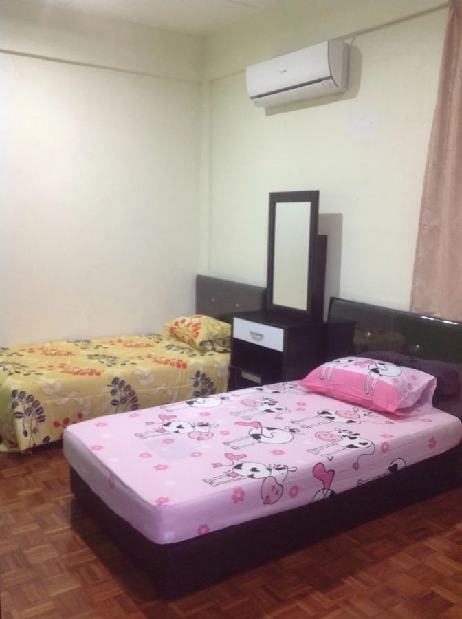 Shared bedroom at Kenneth Care Home with two single beds and a parquet floor