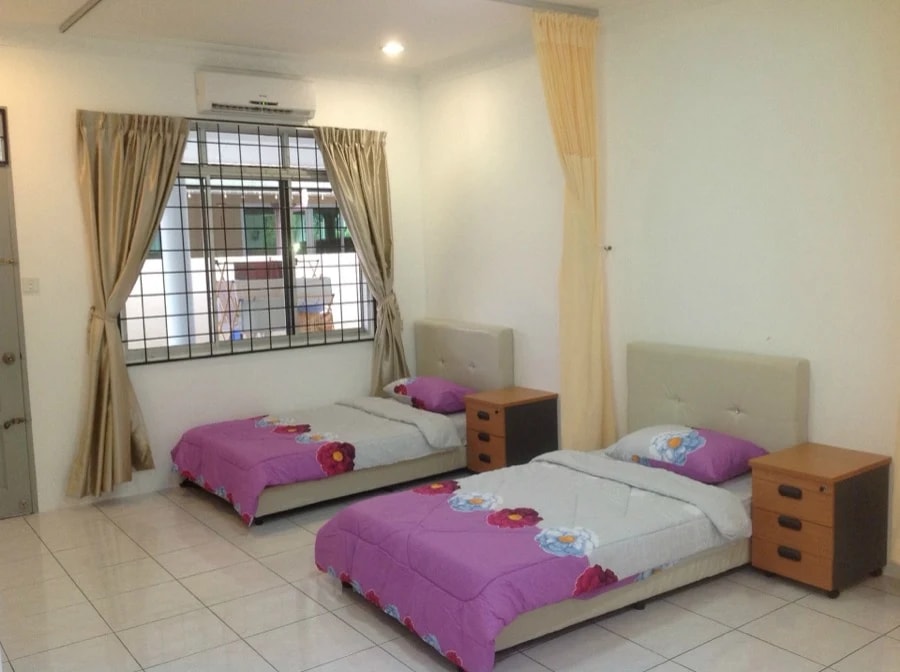 Twin bedroom at Kenneth Care Home with two beds, air conditioning, and a barred window