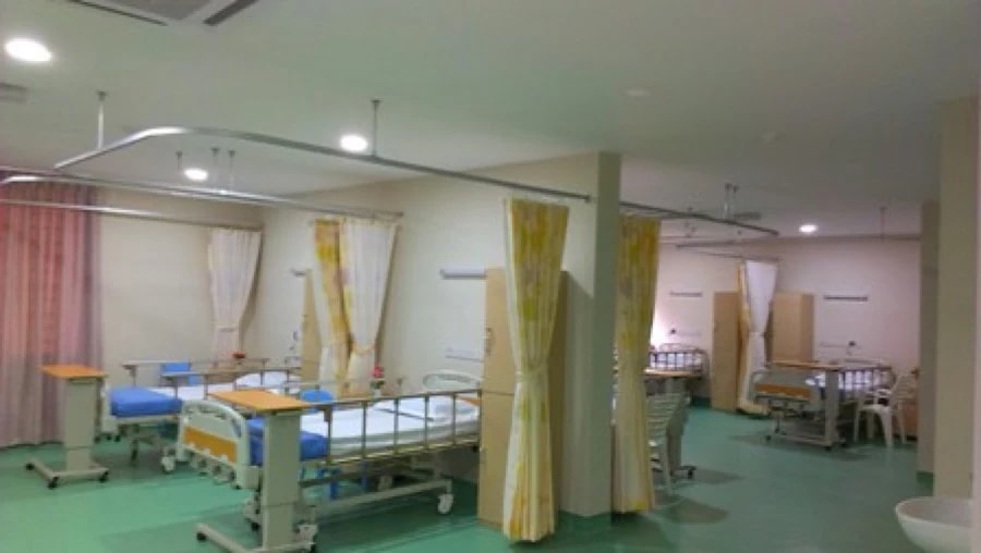 Eight bed shared ward at Tabuan Healthcare and Nursing Centre with curtain dividers
