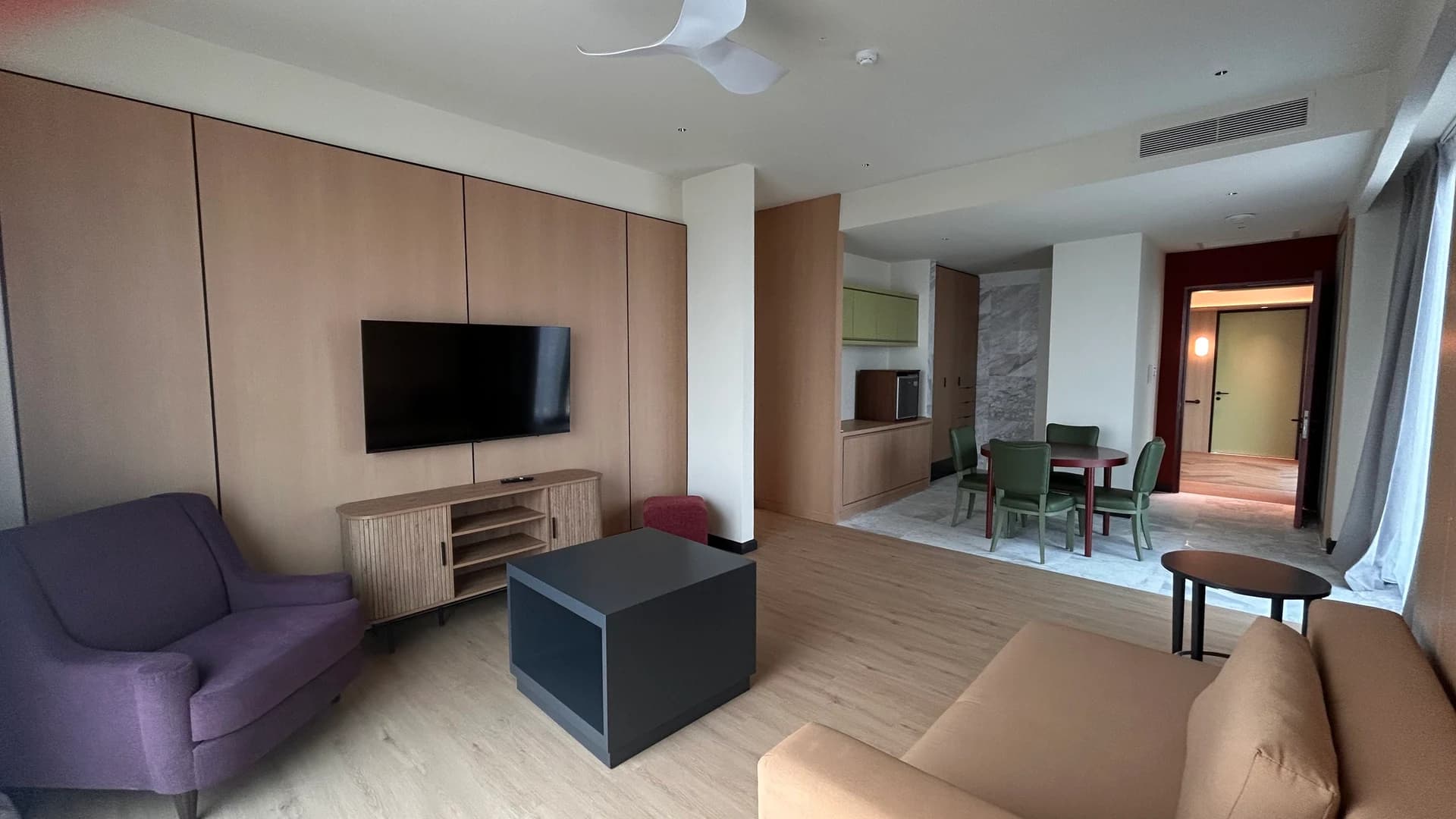 A corner suite with a sofa, armchairs and a TV wall